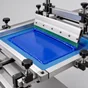 Illustrative screen-printing process with blue ink and a squeegee