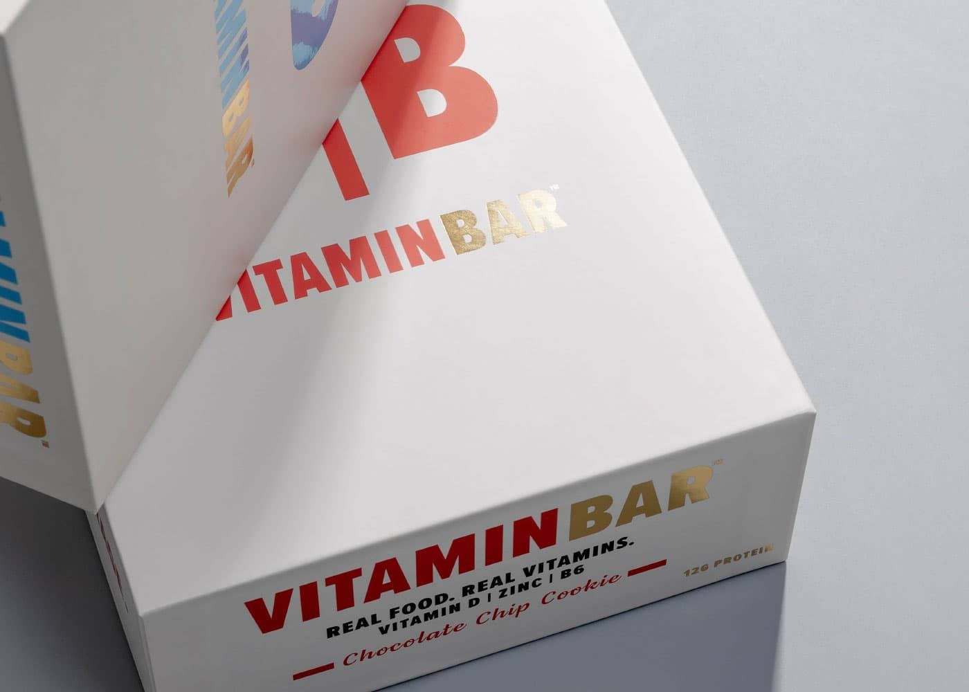 Close-up of a white Vitamin Bar box highlighting metallic gold foil stamping and clean, crisp typography.