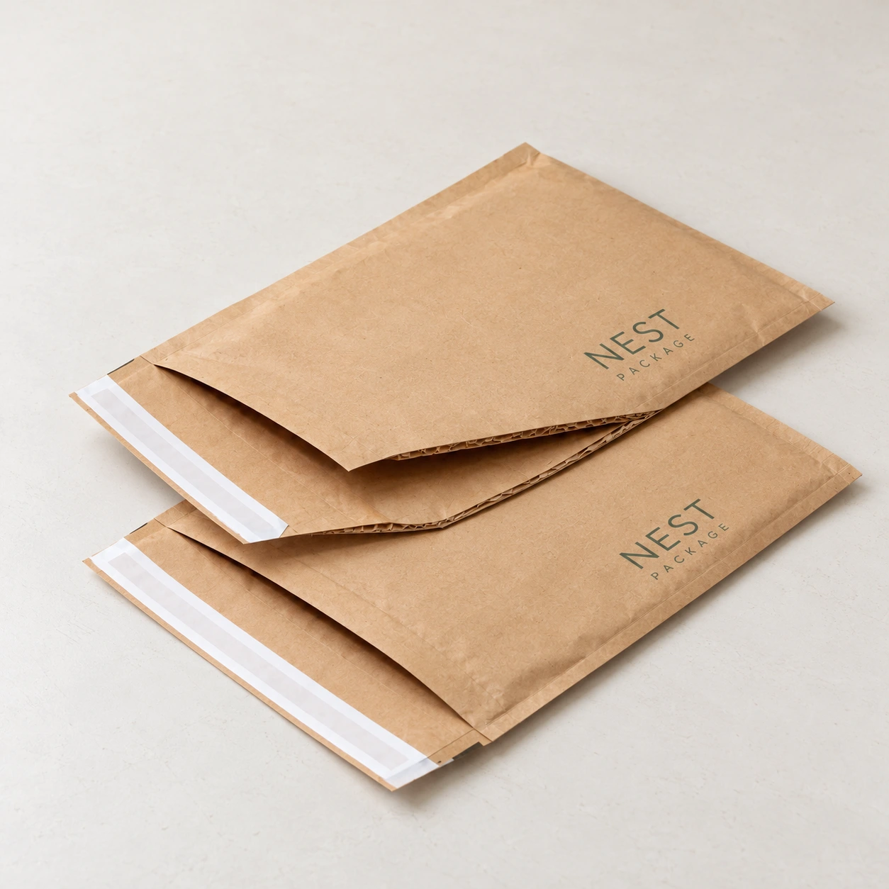 Two padded kraft paper mailers resting on a tabletop